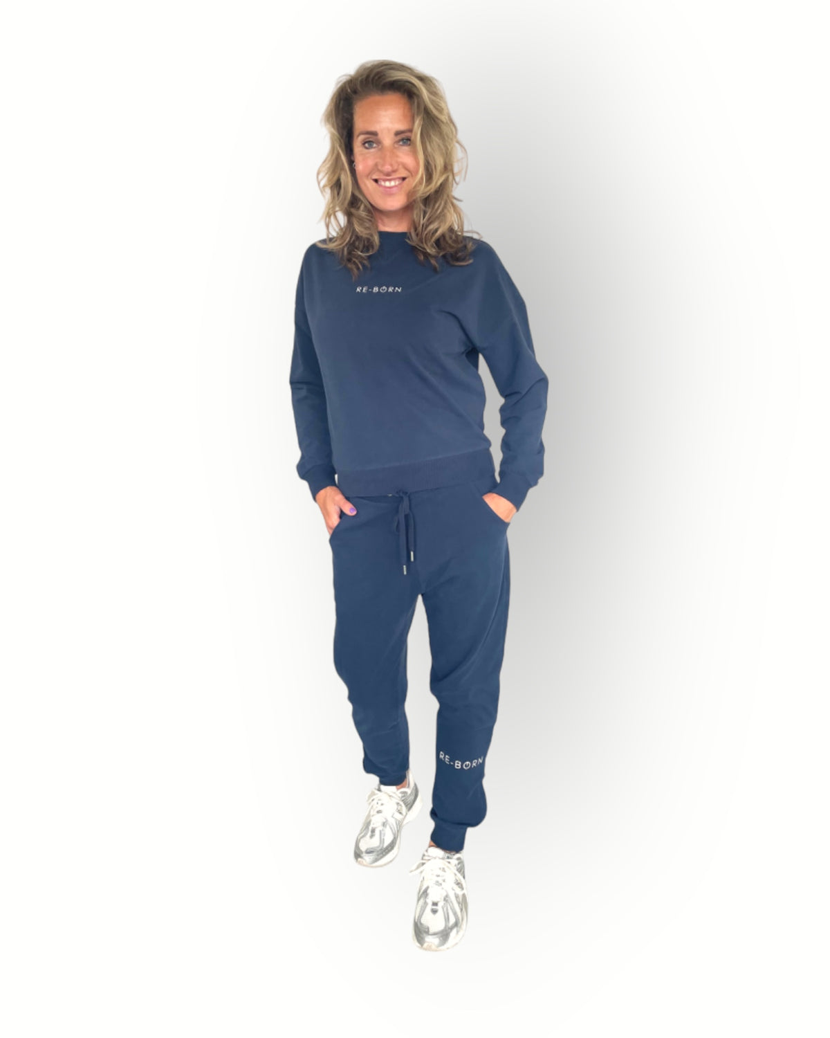 Navy joggers with zippers at the legs and side pockets super soft fabric and model wears matching navy crew sweater