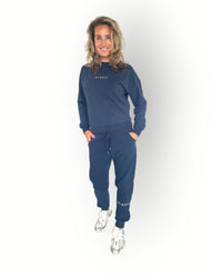 Navy joggers with zippers at the legs and side pockets super soft fabric and model wears matching navy crew sweater
