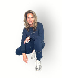 Navy joggers with zippers at the legs and side pockets super soft fabric and model wears navy matching crew top