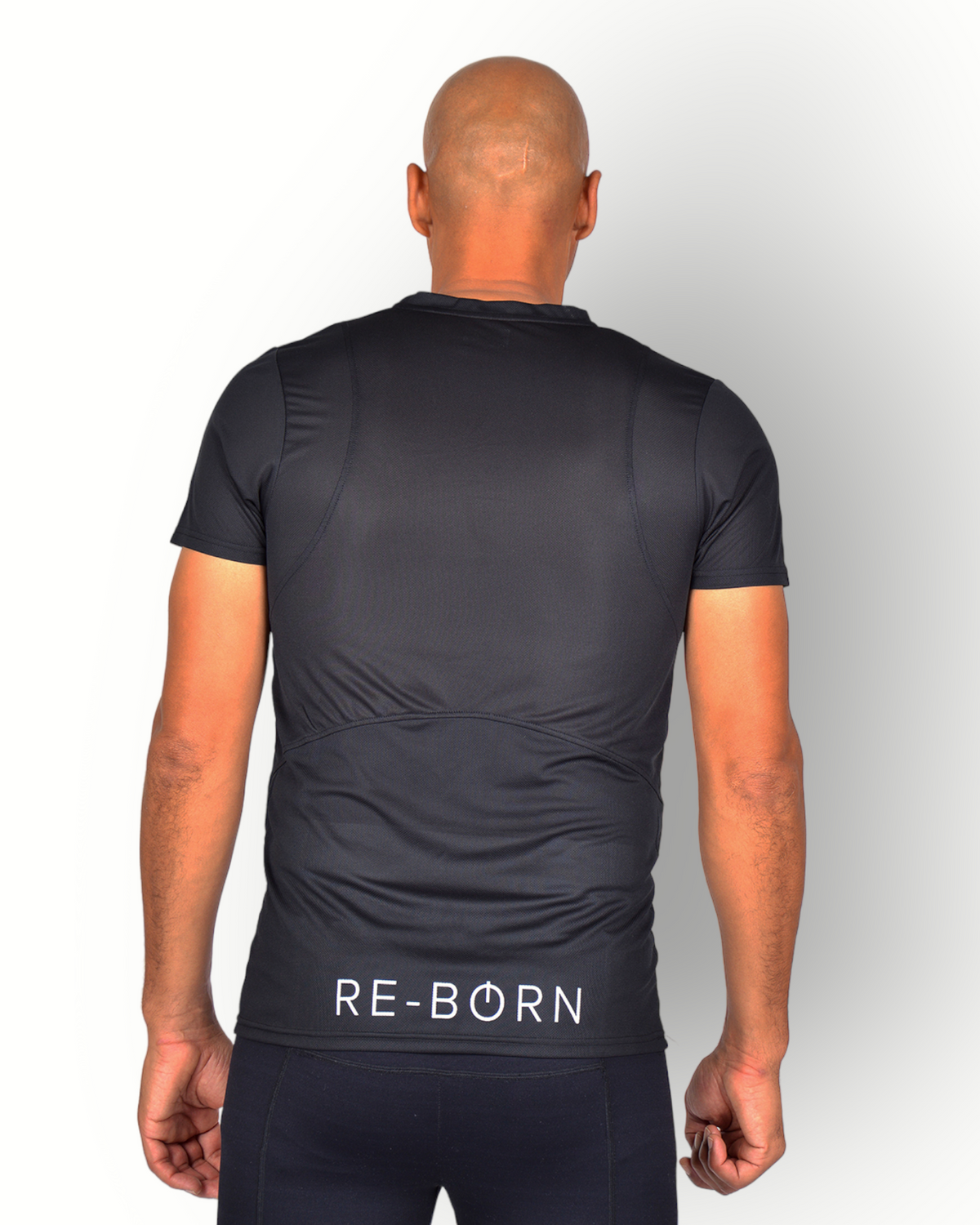 A man wearing a black mesh light weight quick dry sports top short sleeves with logo printed on the backside. 
