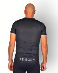 A man wearing a black mesh light weight quick dry sports top short sleeves with logo printed on the backside. 