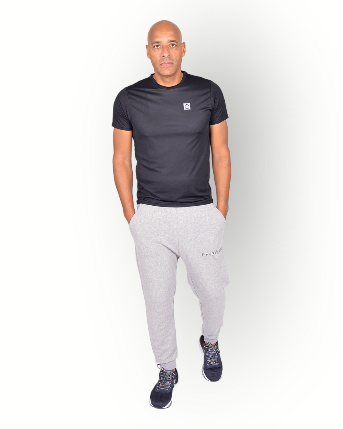 A man wearing a black mesh light weight quick dry sports top short sleeves with logo printed on the backside. 