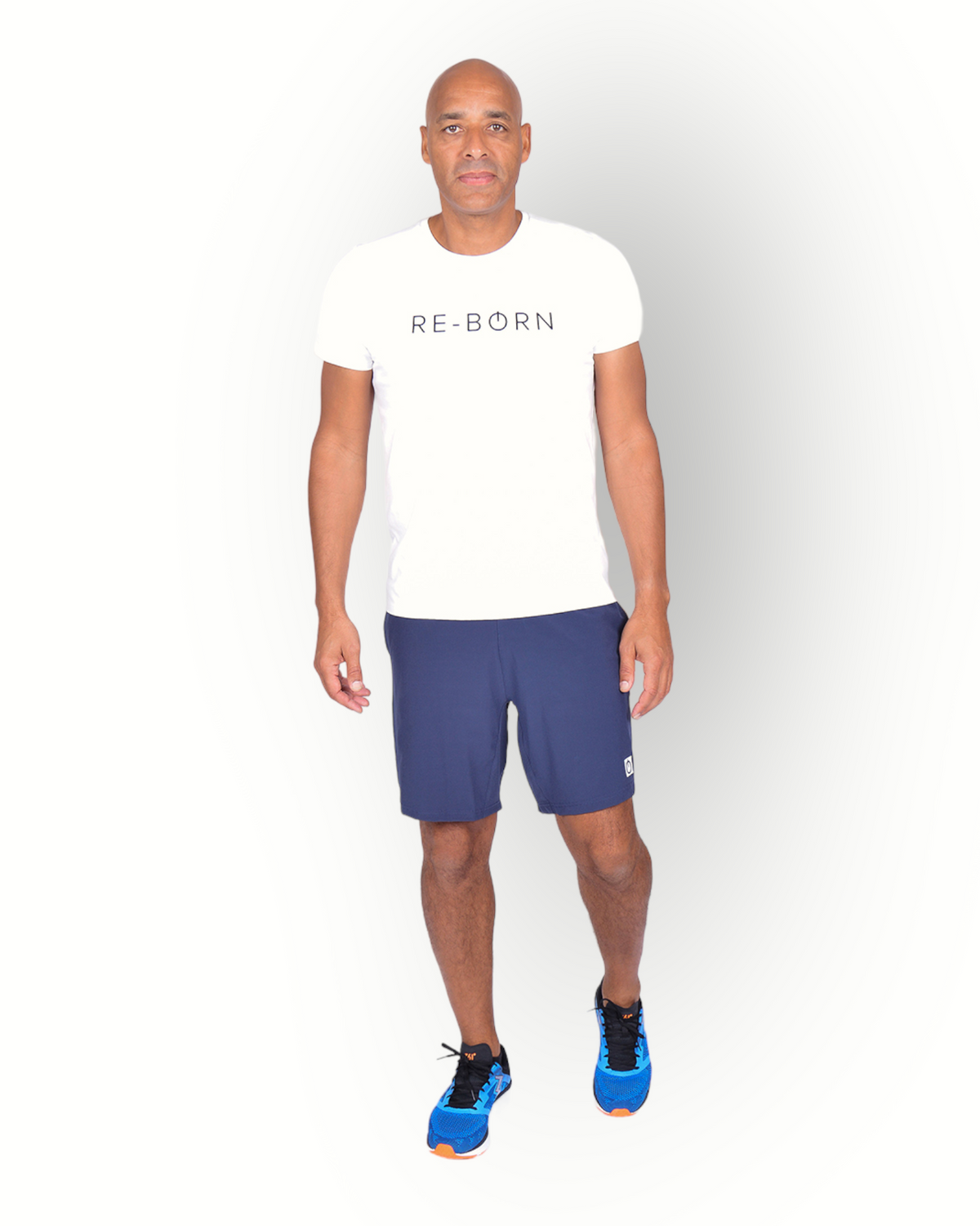 A man wearing a white short sleeve t-shirt with the text 'RE-BORN' on the front.