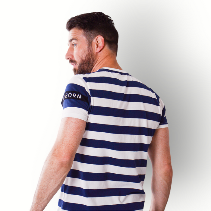 A man wearing a navy and white striped short-sleeve t-shirt with a crew neck and a small logo on the left sleeve.