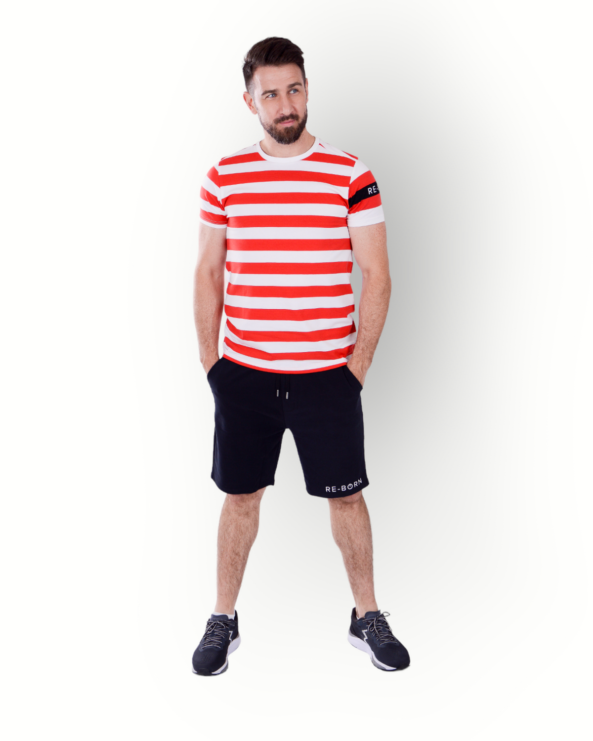 A man wearing a red and white striped short-sleeve t-shirt with a crew neck and a small logo on the left sleeve.