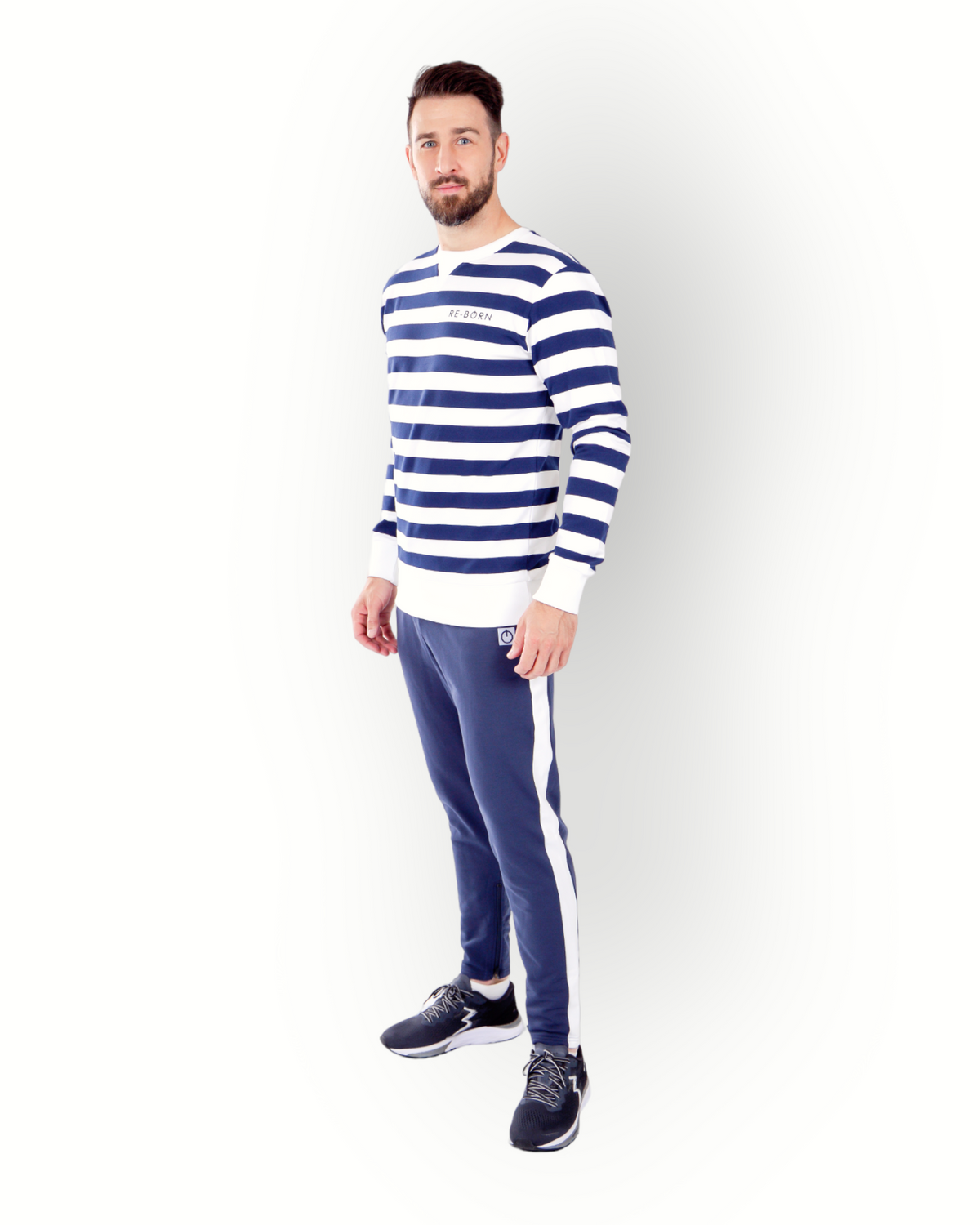 A man wearing a long sleeve navy and white striped crew top with the brand name 'RE-BORN' on the chest.