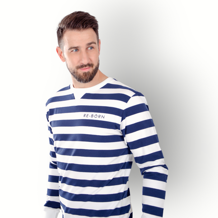 A man wearing a long sleeve navy and white striped crew top with the brand name 'RE-BORN' on the chest.