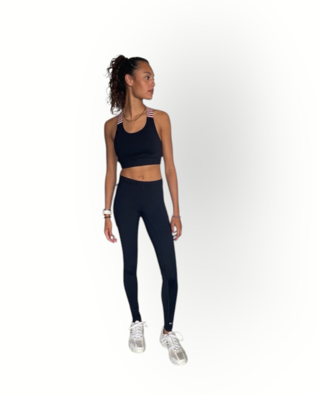 Woman wearing a black athletic outfit on a white background