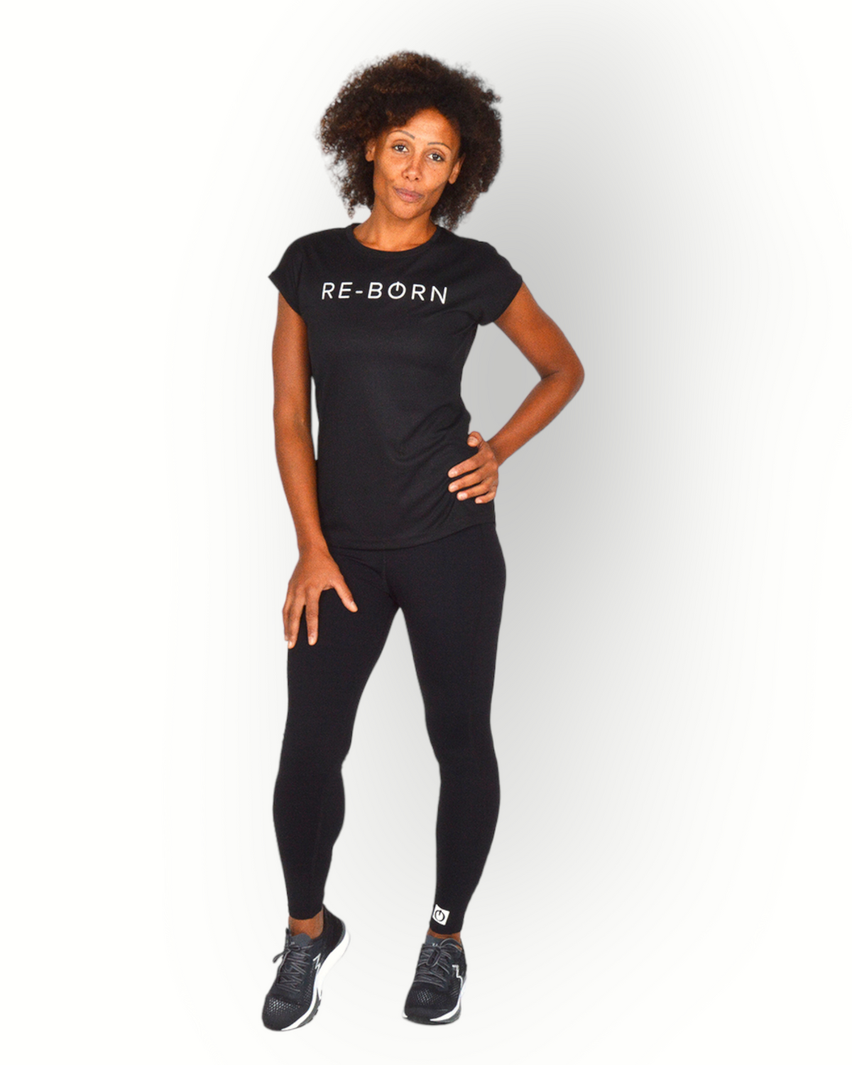 A woman wearing a black short sleeve mesh quick dry super light weight sport top with the text 'RE-BORN' on the chest.