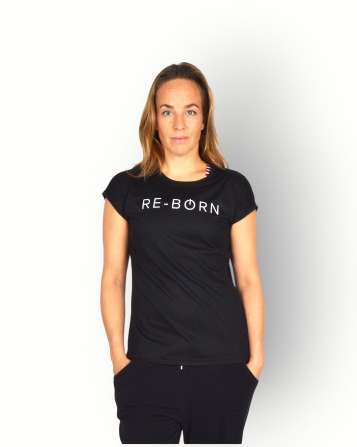 A woman wearing a black short sleeve mesh quick dry super light weight sport top with the text 'RE-BORN' on the chest.