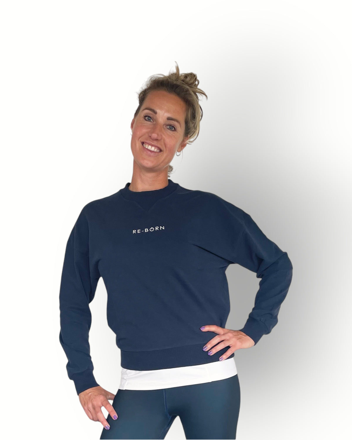 A woman wearing a navy long sleeve crew top with rib detail and a crew neckline in a super soft fabric.